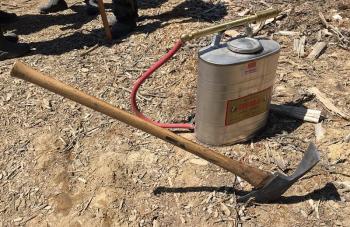When a forestry hose can’t reach, woods fires are battled with hand tools and Indian tanks, which hold 5 gallons of water that is squirted on the fire. It doesn’t have to take a lof of water to put out the worst of a fire to get it in control and to keep it from spreading. (Photo by Holly S. Edwards)