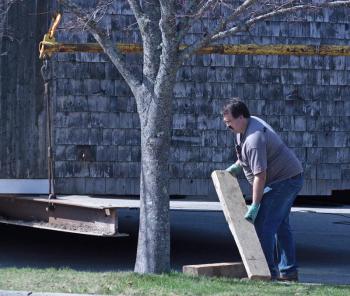 Harley Colwell moves a block during Monday’s 200-year-old barn relocation in Camden. (Photo by Holly S. Edwards)