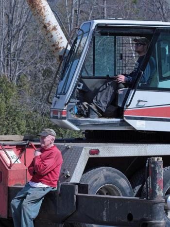 Art Henry, 90, watches while his grandson, Justin Henry, operates the family’s 70-ton crane Monday morning in Camden. (Photo by Holly S. Edwards)