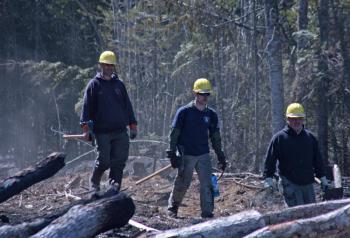 Peter Rollins, Matt Heath and Randy Gagne emerge fromthe woods Friday morning. (Photo by Holly S. Edwards)