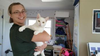 Grace McMullan, Community Events coordinator, and Triscuit, ‘office assistant’ at the shelter. Triscuit is available for adoption. (Photo by Sarah Shepherd)