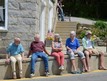 At the former Rockport Corner Shop, now home to Ralston Gallery, the public gathers for the parade. (Photo by Lynda Clancy)