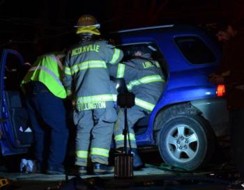 Firefighters work to free Priscilla Jones of Lincolnville from her car after it collided with another car on Route 52 on March 31. She did not sustain life-threatening injuries, but continues to recover nearly two months later. (Photo by Lynda Clancy)