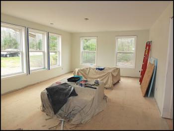A spacious living room awaits the final touches for its new family.