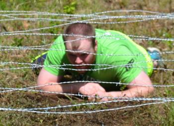 Then, under barbed wire and through the mud. (Photo by Lynda Clancy)
