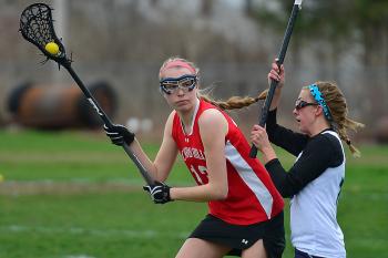 Camden Hills Emma Brownawell, left, works to get past Oceanside’s Makaye Stone during Wednesday’s game. (Photo by Ron Hawkes)