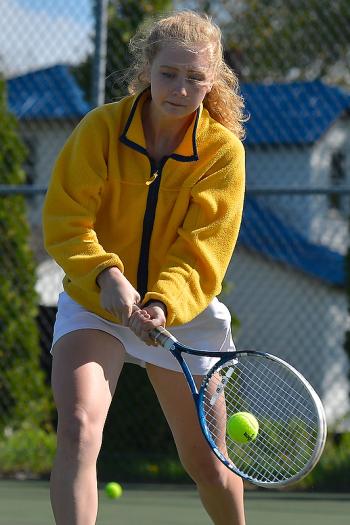 Lincoln Academy’s Nettie Hoagland returns a serve. (Photo by Ron Hawkes)