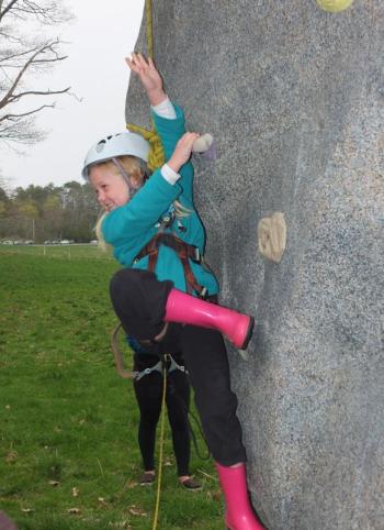 Madelyn Payne tries her hand at the rock wall.