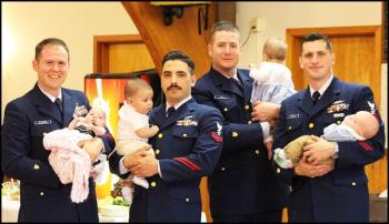 Being in the Coast Guard does not get you out of Dad duty. From left to right MK1 Dettmer with daughter Josephine; FS2 Loya with son Jethro; BM2 Veit with daughter Mary; and BM1 Ramirez with son Hudson. (Photo by Ellie Curtis)