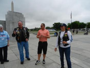 Ralph gives a speech, while to the left is volunteer Donna Ditchett of Tenants Harbor and to the right is another member of the BWI Brownies motorcycle escort group.