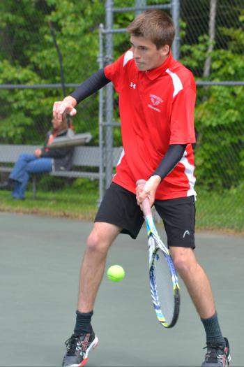 Camden’s No. 1 doubles partner Colby Arau returns a hard shot that jammed him a little. (Photo by Ron Hawkes)