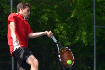 Camden’s No. 1 singles player Austin Pohlman returns a volley. (Photo by Ron Hawkes)