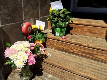 David Conary could often be found recently sitting in this vestibule, next to French and Brawn Market Place on Elm Street. He will never sit there again, and this week flowers have been left in his place. Conary was 55 when he was found deceased June 15 in a stand of trees between the Knox Mill and Rite Aid parking lots. (Photo by Holly S. Edwards)