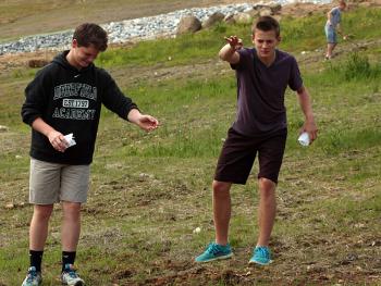 Two Camden-Rockport Middle School students help spread a mixture of flower seeds assembled specifically to attract and sustain bees and butterflies at the Camden Snow Bowl on Thursday morning. The community service project was one of 10 end-of-year projects undertaken by the eighth-grade class this year, the day before they attend a promotion ceremony at the school and prepare to enter high school in the fall. (Photo by Holly S. Edwards)