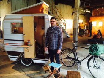 Kevin Cyr with his bike-pulled camper exhibit “Little Tag Along” (Photo courtesy Stacy Campbell)