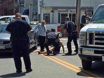 A North East Mobile Health Services crew assists Robin Pietila of Scarborough after she was hit by a car while she was walking in a crosswalk Monday around noon. (Photo by Holly S. Edwards)