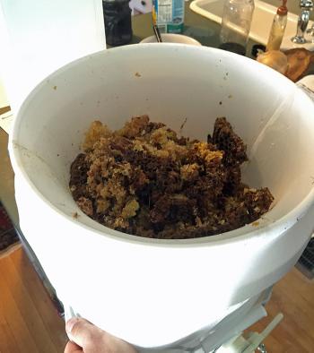 Crushing and straining the bit of salvageable honey from the Waldoboro tree cutout. (Photo by Holly S. Edwards)