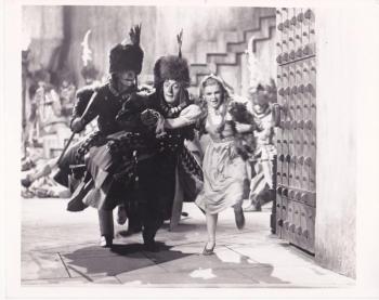The first photo was taken in October 1938, when director Richard Thorpe began filming The Wizard of Oz at Metro-Goldwyn-Mayer's Culver City (California) studios. Judy Garland's Dorothy wore excessive make-up, a blonde wig, and plain, rhinestone ruby slippers with no bow. (Photo courtesy the collection of John Fricke)