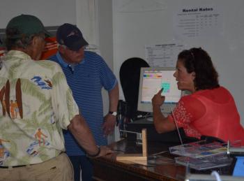 Camden Snow Bowl’s Assistant Manager Beth Ward shows Select Board members Leonard Lookner and Don White how the software runs at the Snow Bowl. (Photo by Lynda Clancy)