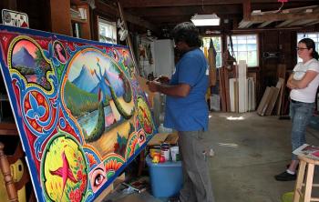 ‘I could stand here and watch him paint all day,’ said Kendra Denny of Rockland, Haider Ali’s friend, host and fellow artist. (Photo by Holly S. Edwards)