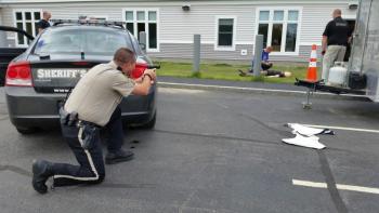 Tactical training with Sgt. Matt Elwell providing cover for an injured officer. (Photo by Sarah Shepherd)