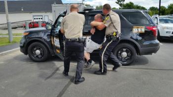 Chief Deputy Tim Carroll and Sgt. Matt Elwell remove an “injured” Deputy Paul Spear from a cruiser. (Photo by Sarah Shepherd)