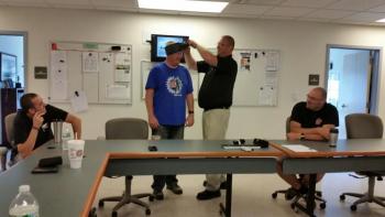 Deputy Justin Hills, class instructor, demonstrates on Sgt. Ken Smith about how the tourniquet can hold the gauze hemostatic bandage in place for a head trauma injury. (Photo by Sarah Shepherd)
