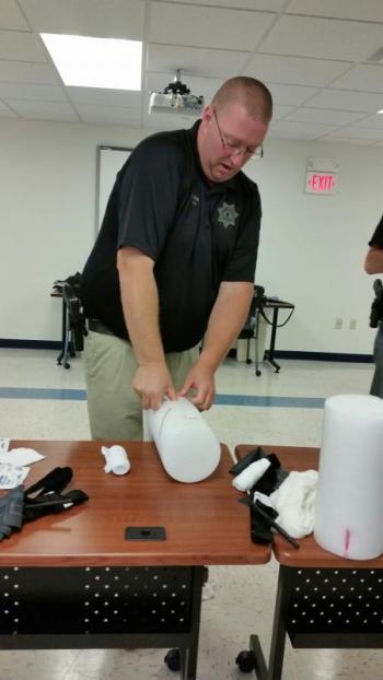 Instructor and Deputy Justin Hills demonstrates how to stop traumatic bleeding. (Photo by Sarah Shepherd)