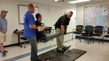 Deputy Jeremy Joslyn, role playing as an injured officer, is transported by Sgt. Ken Smith during a training exercise. (Photo by Sarah Shepherd)
