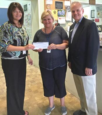 Camden National’s Tracy King and Charlie Milan, loan officers from the Bangor Exchange Street location, present a recent donation check to Rowena Griffin of the Bangor Area Homeless Shelter.