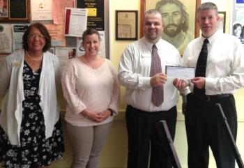 Employees from Camden National’s Rockland branch present proceeds from the bank’s Hope@Home program to Stephanie Primm, executive director of Hospitality House. (Pictured L-R) – Randy Cruz, branch manager; Primm; Jane Merrill, senior retail loan officer; and April Murray, assistant branch manager.