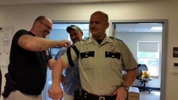 Knox County Deputy Paul Spear and Sgt. Lance Mitchell apply a combat application tourniquet to Chief Deputy Tim Carroll. (Photo by Sarah Shepherd)