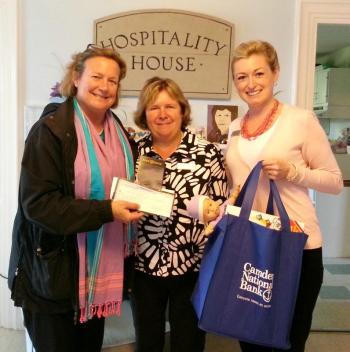 Stephanie Primm, executive director of Hospitality House, receives a collection of children’s toys and Hope@Home donations from Victoria Bryant, mortgage loan originator, and Jody Landrith, branch manager, from Camden National’s downtown Camden location.