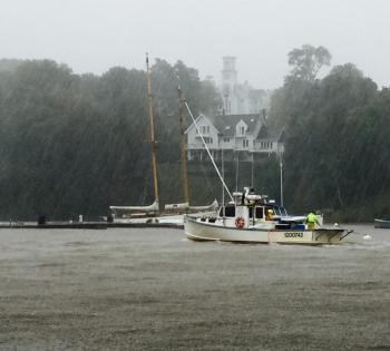 A lobster boat returns to Rockport Harbor in the pelting rain. (Photo by Lynda Clancy)