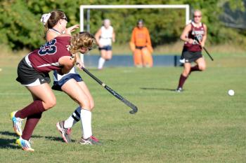 Oceanside’s Mary Allen, back, runs right into the stick on this play as she went after the ball. No injuries were sustained. (Photo by Ron Hawkes)