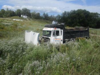 Elisabeth Bormet, 33, of Belfast, was driving this Freightliner dump truck Tuesday afternoon when she said her thumb became entangled in the truck’s steering wheel cover, causing her to lose control and crash (Courtesy Waldo County Sheriff’s Office)