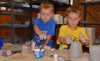 Brothers Lucas and Evan Kimball work on their cups at the Hope Clay studio, at Hope Spinnery. Their cups will be for sale Saturday evening. (Photo by Lynda Clancy_