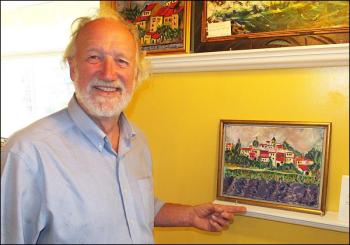 Ronald van Heeswijk talks about one of the many paintings that hang in the Owl & Turtle Bookshop at 33 Bayview Street in Camden.