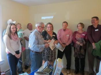 A volunteer talks about his experience with the project while attendees watch. (photo by Erica Thoms)