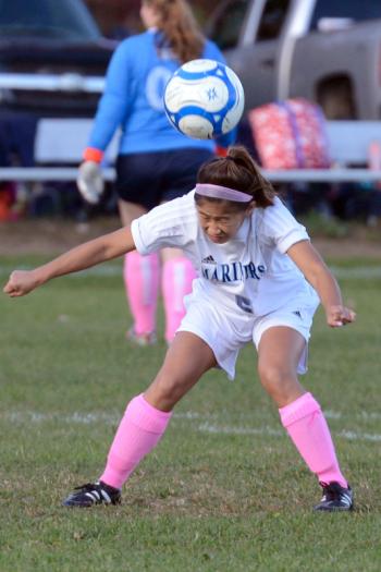 Oceanside’s Lily McVetty heads the ball back towards the 18 from the sideline. (Photo by Ron Hawkes)