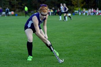 John Bapst’s Betsy Spear clears the ball out for the Crusaders. (Photo by Ron Hawkes)