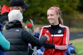 It was senior day for the girls soccer today and Emma Gutheinz takes her flower to her parents. This is done at the last regular season game to thanks the parents for all the support. (Photo by Ron Hawkes)