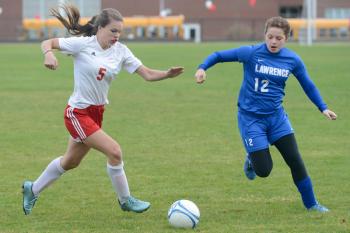 Camden’s Bryn Anderson takes the ball to the goal hard in the first half. (Photo by Ron Hawkes)