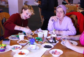 Clara Snow, left, and Judy Lewis work on decorating some cupcakes together. (Photo Courtesy Of Charles Hamm)