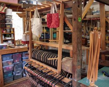 The O’Brien’s early 19th century wooden loom just keeps weaving along, albeit with a few metal pieces added to the joints to keep it plumb and tight.