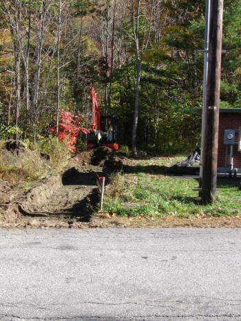 Brendan begins excavation on the trail. (Photo Courtesy of Karen Brace)