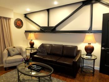 The steel beam was part of the original iron work in the building and got incorporated into the rooms design.