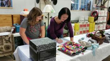 Kim and Morgan Lowe making their bids at the silent auction. (Photo by Sarah Shepherd)