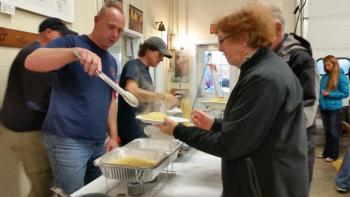 Rockport firefighter John Wickenden serves up some hot spaghetti. (Photo by Sarah Shepherd)