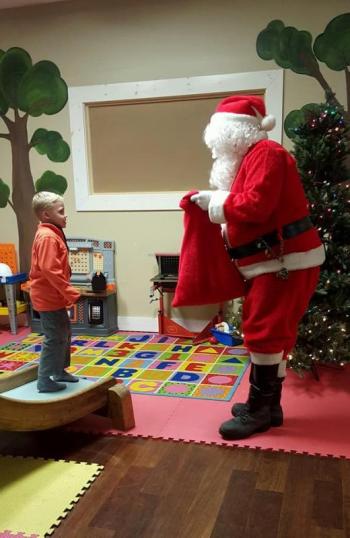 Aiden Jandreau gets a present from Santa.